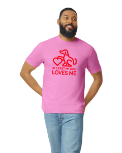 Man posing in a pink t shirt with a image outline of a dog paw on a heart that says at least my dog loves me